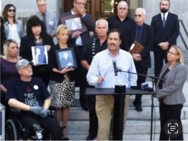 Bob Pack speaking alongside families and community partners at a public advocacy event